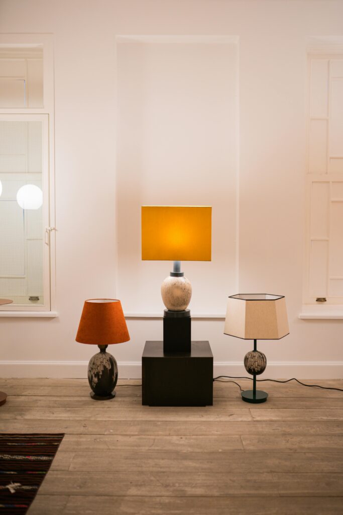 Modern living room featuring stylish lamps and wooden flooring.