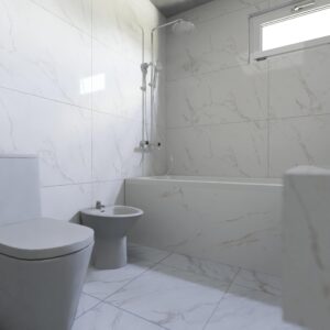 Elegant bathroom with white marble tiles and contemporary fixtures.